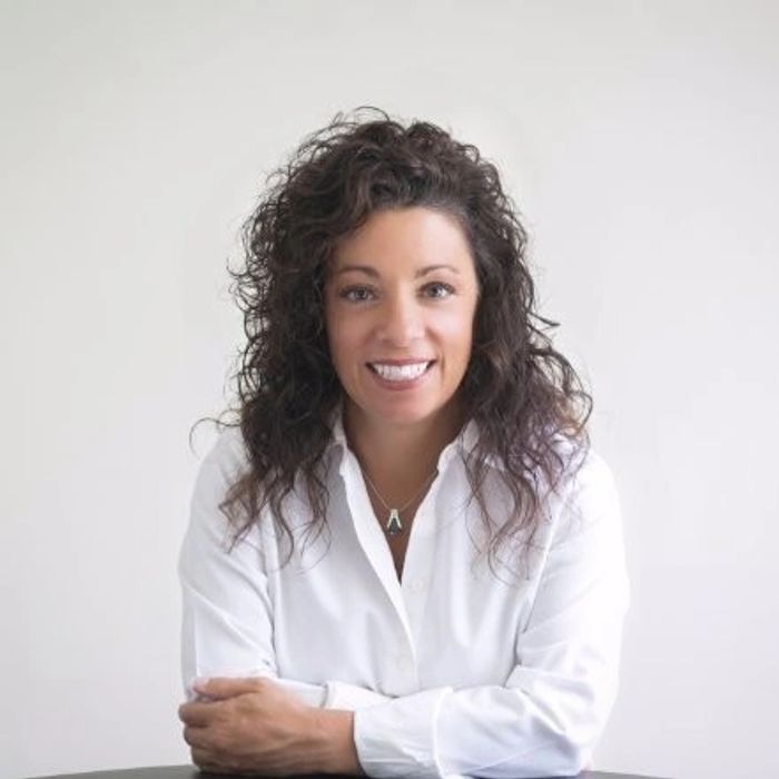 Lisa DeFalco smiling in a white shirt